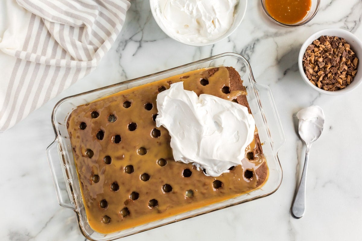 whipped cream spread on top of a chocolate cake