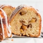 a slice of cinnamon peach bundt cake on a spatula