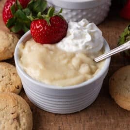 closeup of a bowl of vanilla pudding with whipped cream