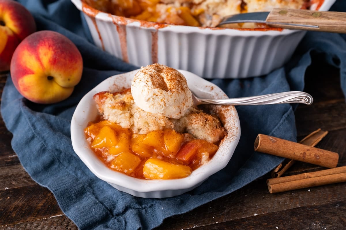 peach cobbler in a bowl with ice cream