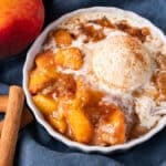 cinnamon peaches with oat streusel and ice cream in a bowl