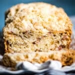 rhubarb bread on a plate with buttery crumbs