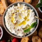 feta whipped in a bowl with olive oil, black pepper and basil