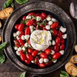 overhead view of a bowl of caprese salad on a table