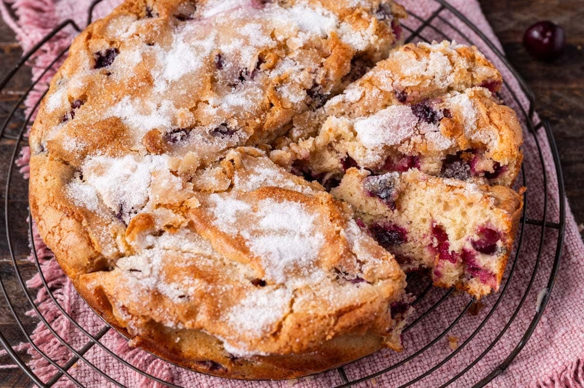 fresh cherry cake with sugar crunch top on a wire rack