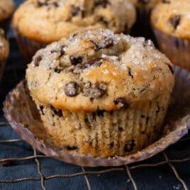 a chocolate chip muffin sitting on a wire rack