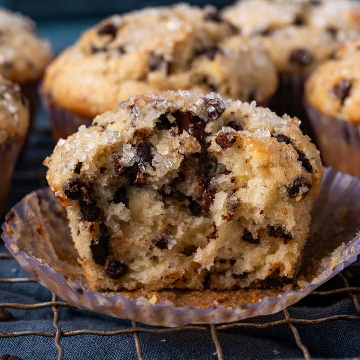 half of a chocolate chip muffin on a wire rack