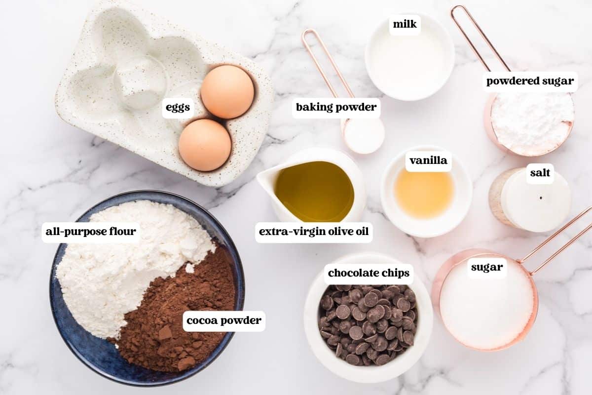 ingredients for a chocolate olive oil cake on a table