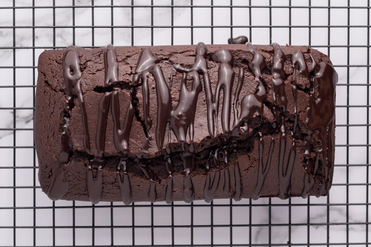 overhead view of a chocolate loaf cake with olive oil
