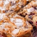 fresh cherry cake with sugar crunch top cut in slices on a table