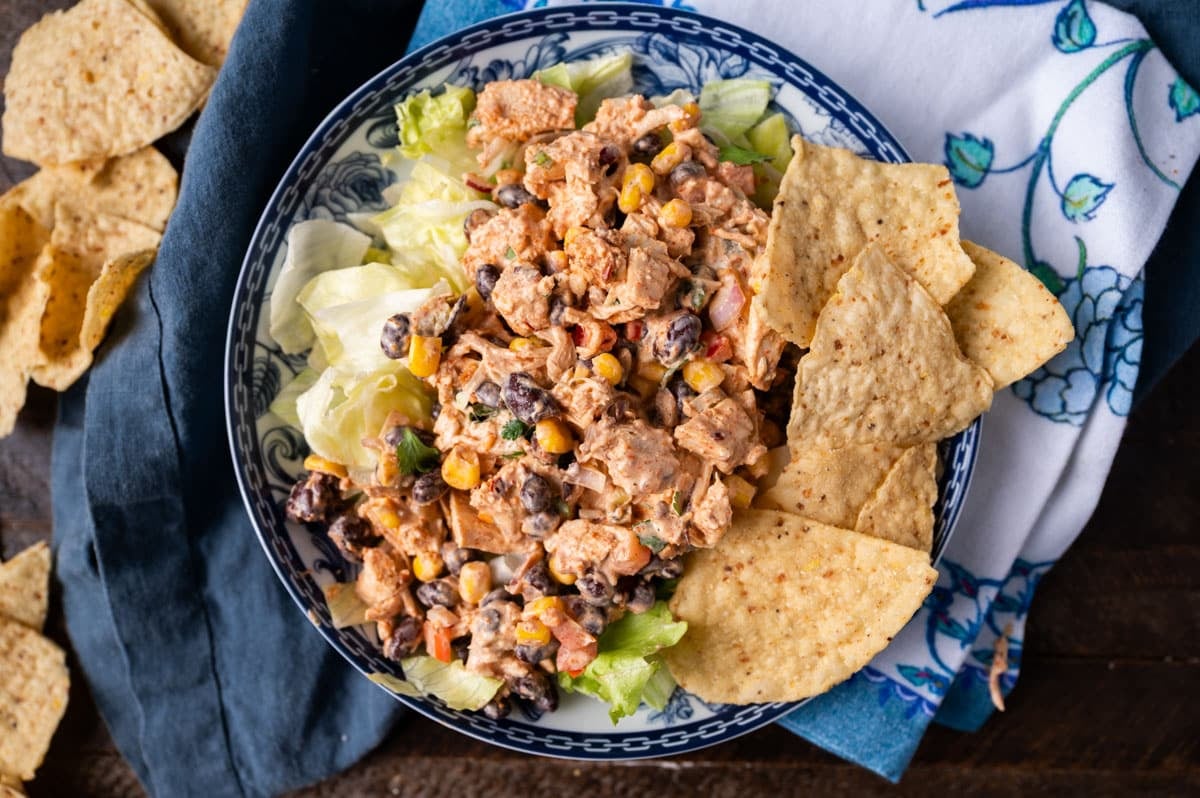 southwest chicken salad over lettuce with tortilla chips on a table