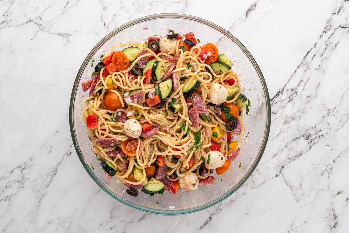 pasta salad tossed in a glass bowl
