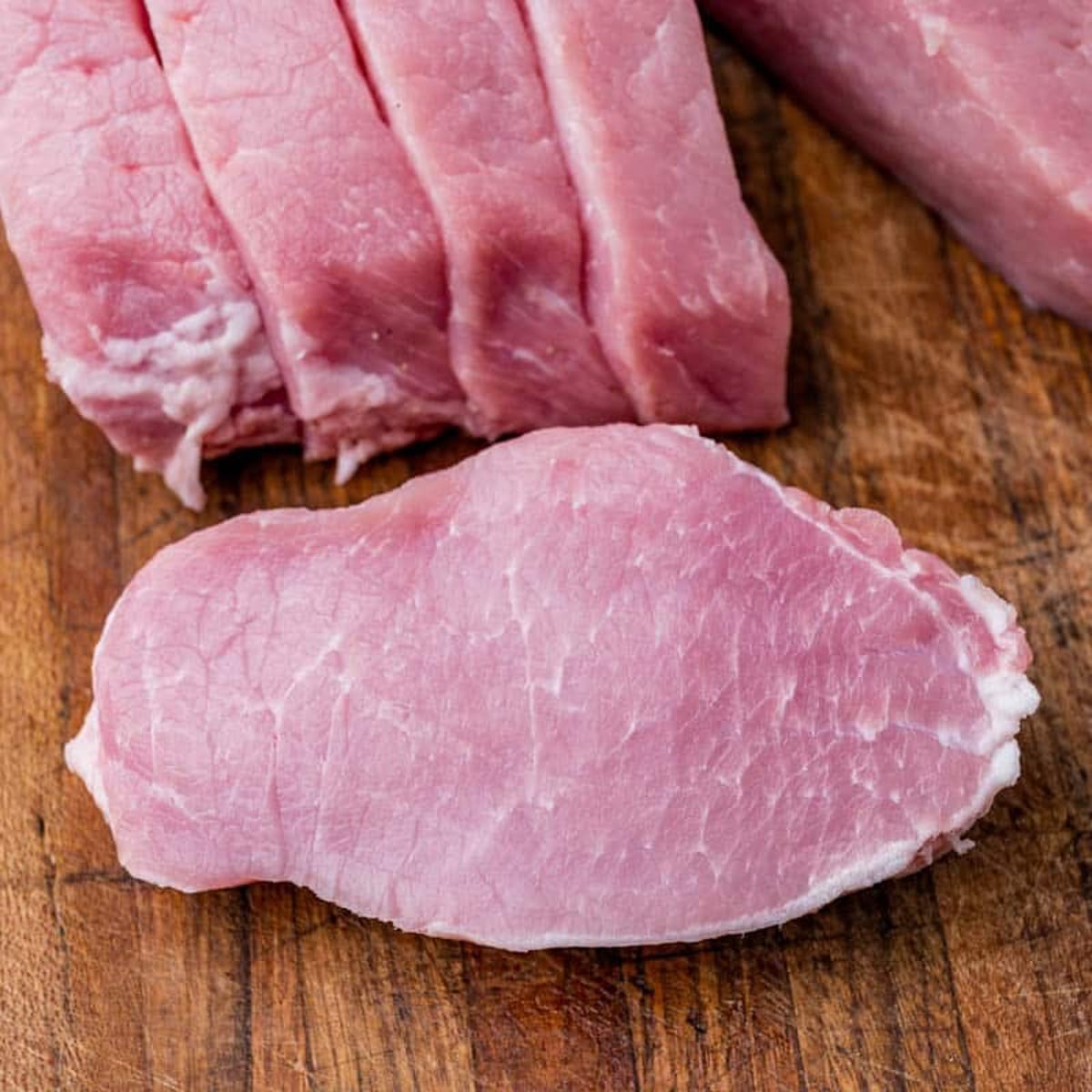 sliced pork chops on a cutting board