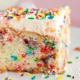 a piece of funfetti birthday cake on a plate