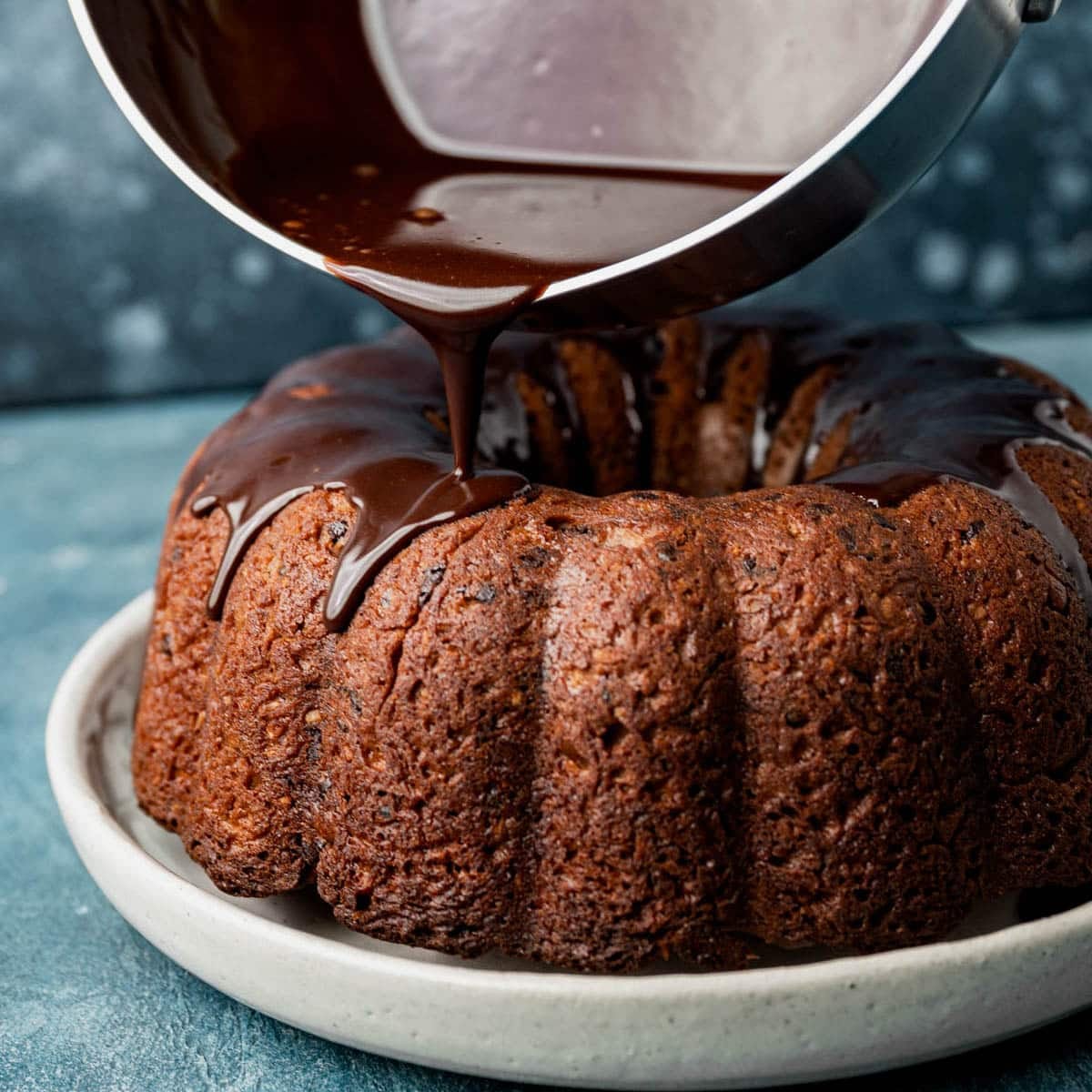 chocolate glaze pouring over a bundt cake