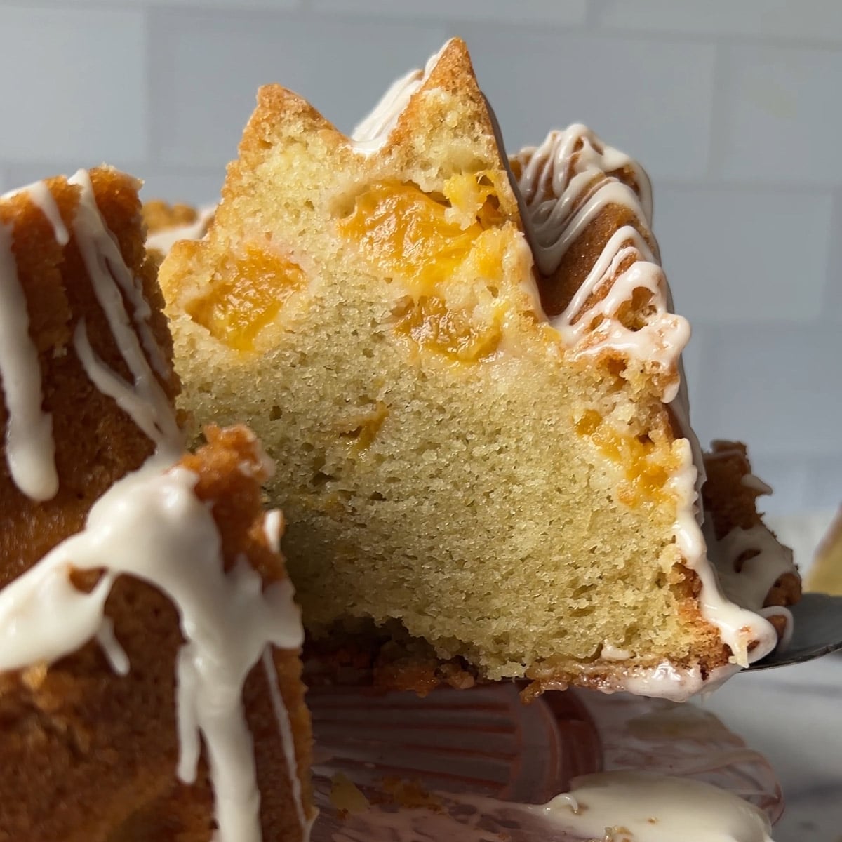 a slice of peach pound cake on a spatula