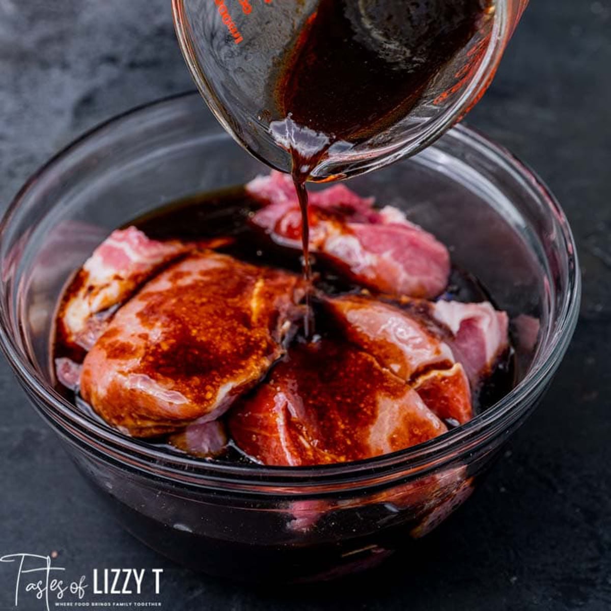 marinade pouring over pork ribs in a bowl