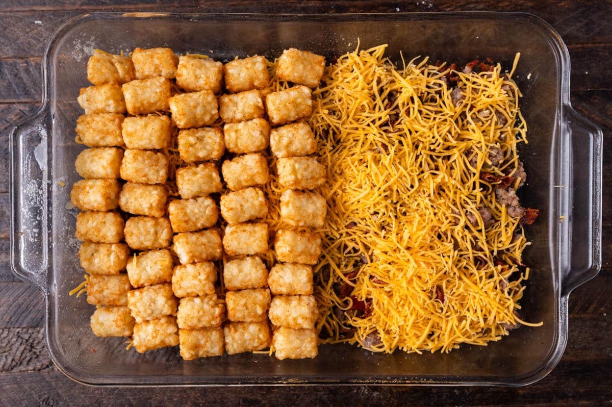 an unbaked tater tot casserole with cheddar cheese