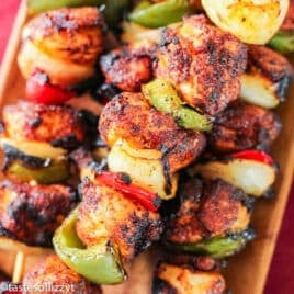 closeup of bbq chicken skewers on a plate