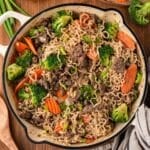overhead view of beef and ramen noodles stir fry in a skillet