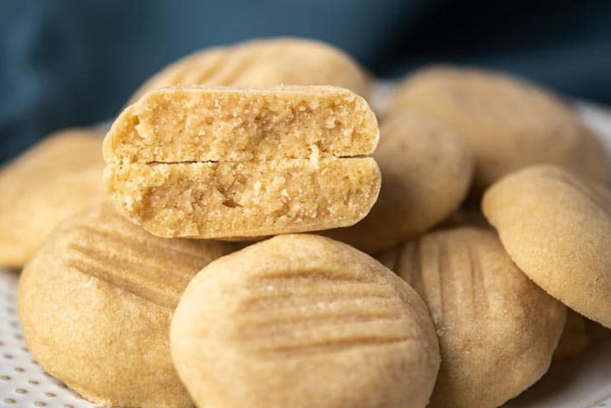 a plate of brown sugar butter cookies with one cut in half