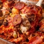a spoon scooping out a pizza casserole