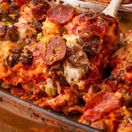 a spoon scooping out a helping of bubble up pizza