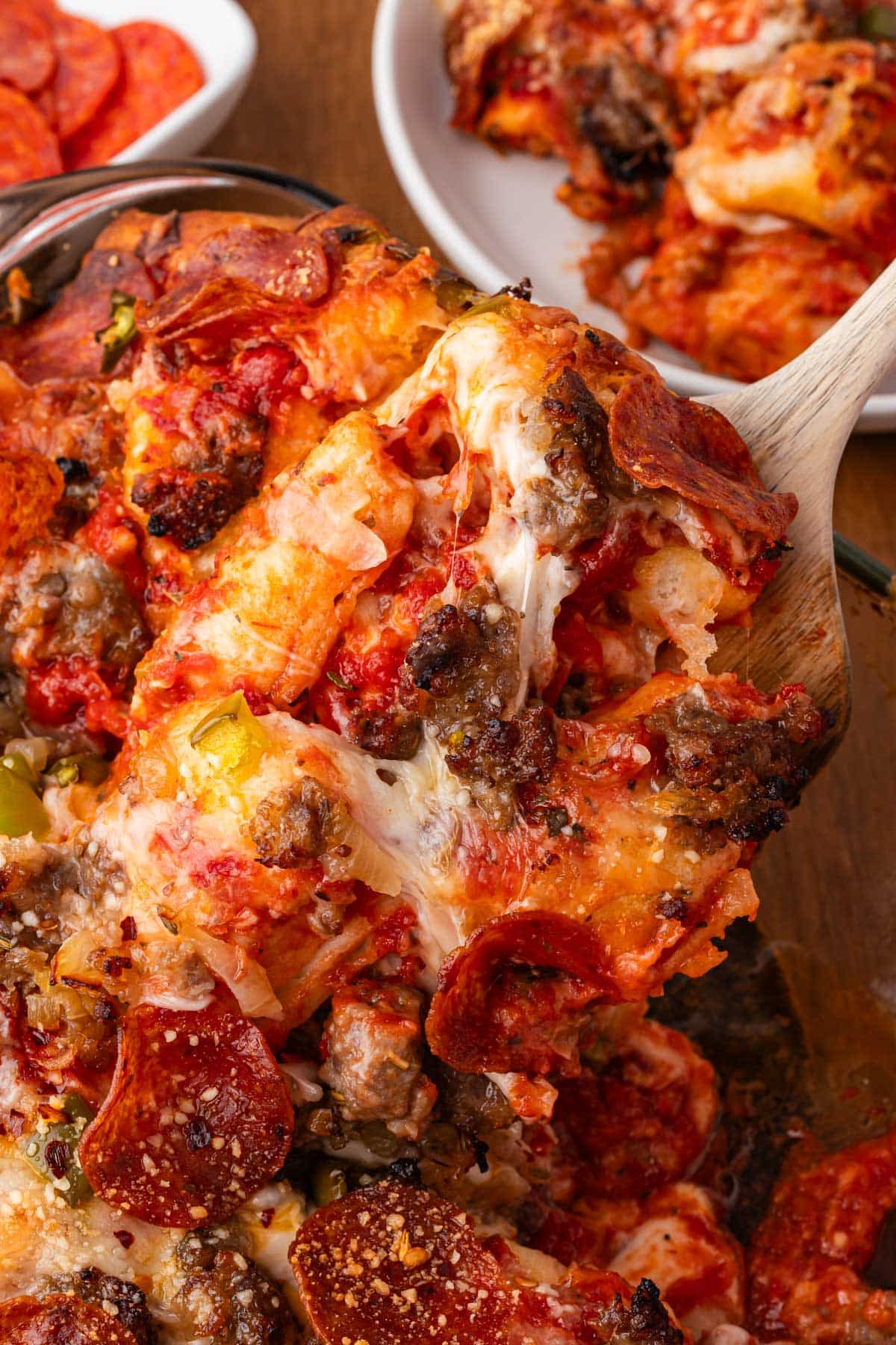 a spoon scooping out a helping of bubble up pizza