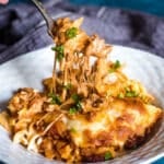 a fork pulling up cheesy casserole