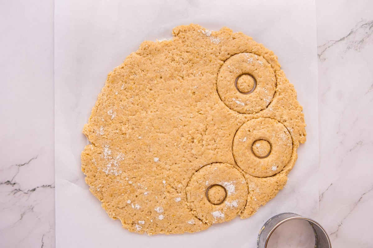 donut batter cut on a piece of parchment paper