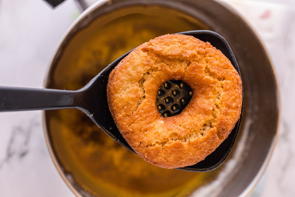 a fried donut on a spatula