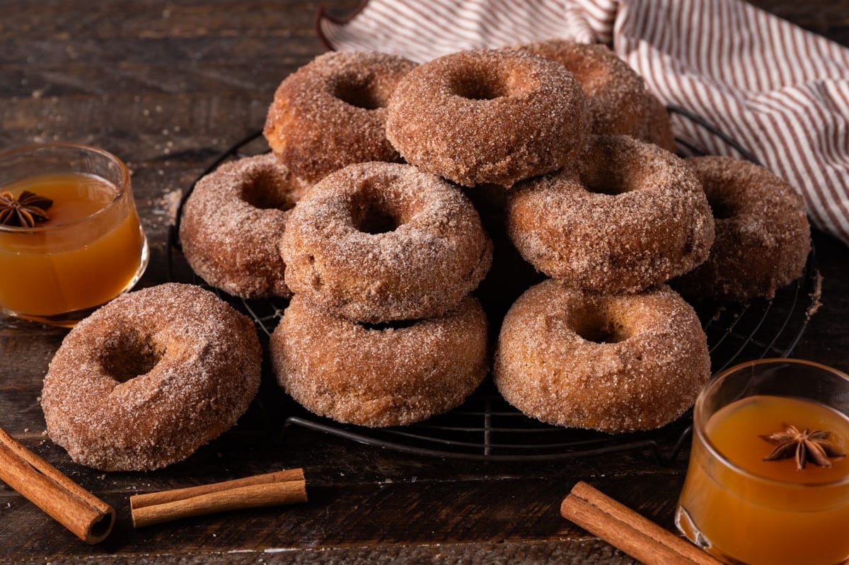 a stack of apple cider donuts on a table