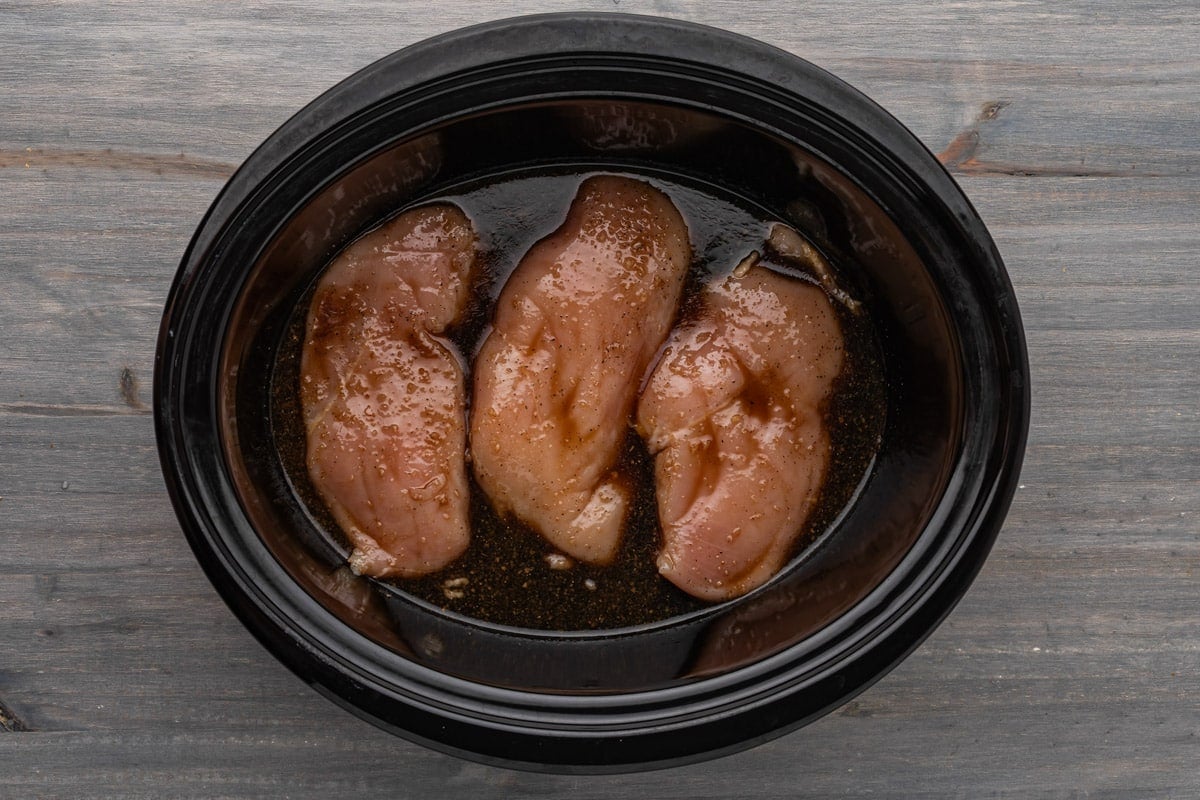 3 chicken breasts in teriyaki sauce on a table