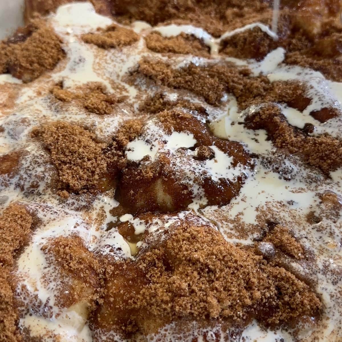 cream pouring over unbaked rolls