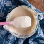 sourdough discard in a cup on a spoon
