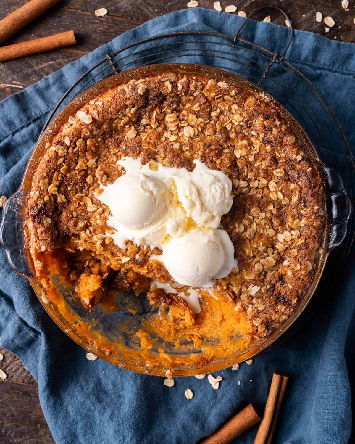 overhead view of sweet potato crisp with ice cream on top on a table